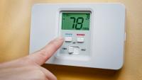 A thermostat shows 78 degrees. A person's finger hovers over the "cool" button.